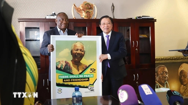 លោក Cyril Ramaphosa ប្រធានាធិបតីអាហ្រ្វិកខាងត្បូង ប្រធានគណបក្ស ANC (ខាងឆ្វេង) ជូនវត្ថុអនុស្សាវរីយ៍ជូនលោក Phan Dinh Trac (រូបថត៖ vnanet.vn)